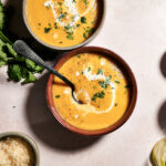 two bowls of creamy butternut squash and potato soup.