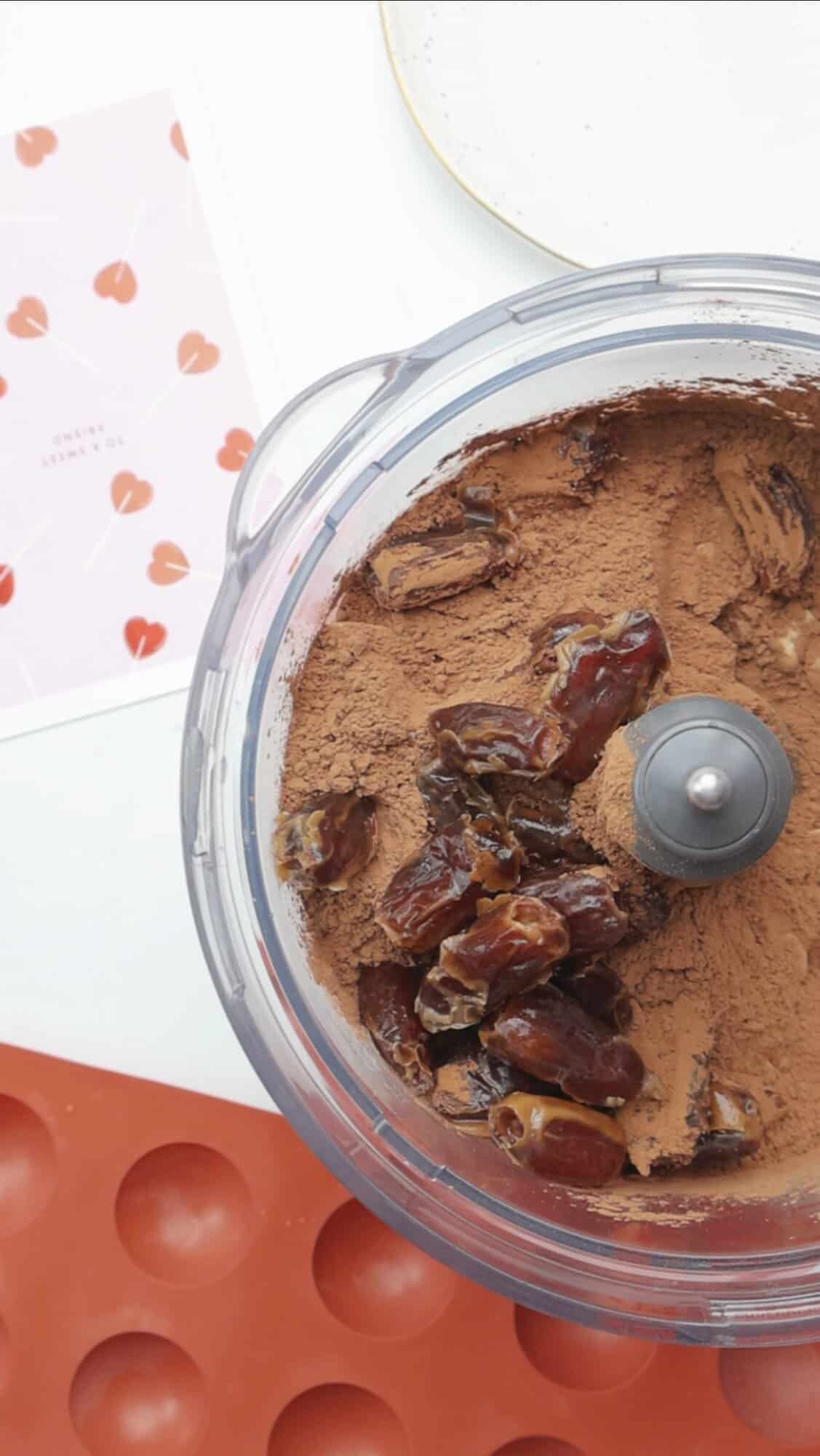Dates and cocoa powder in a food processor before blending into a fudgy truffle base.