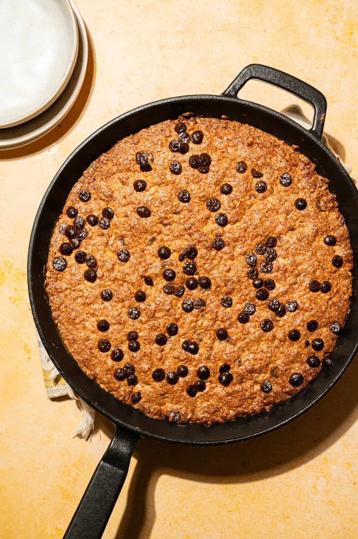 Golden brown butter oatmeal chocolate chip skillet cookie fresh from the oven