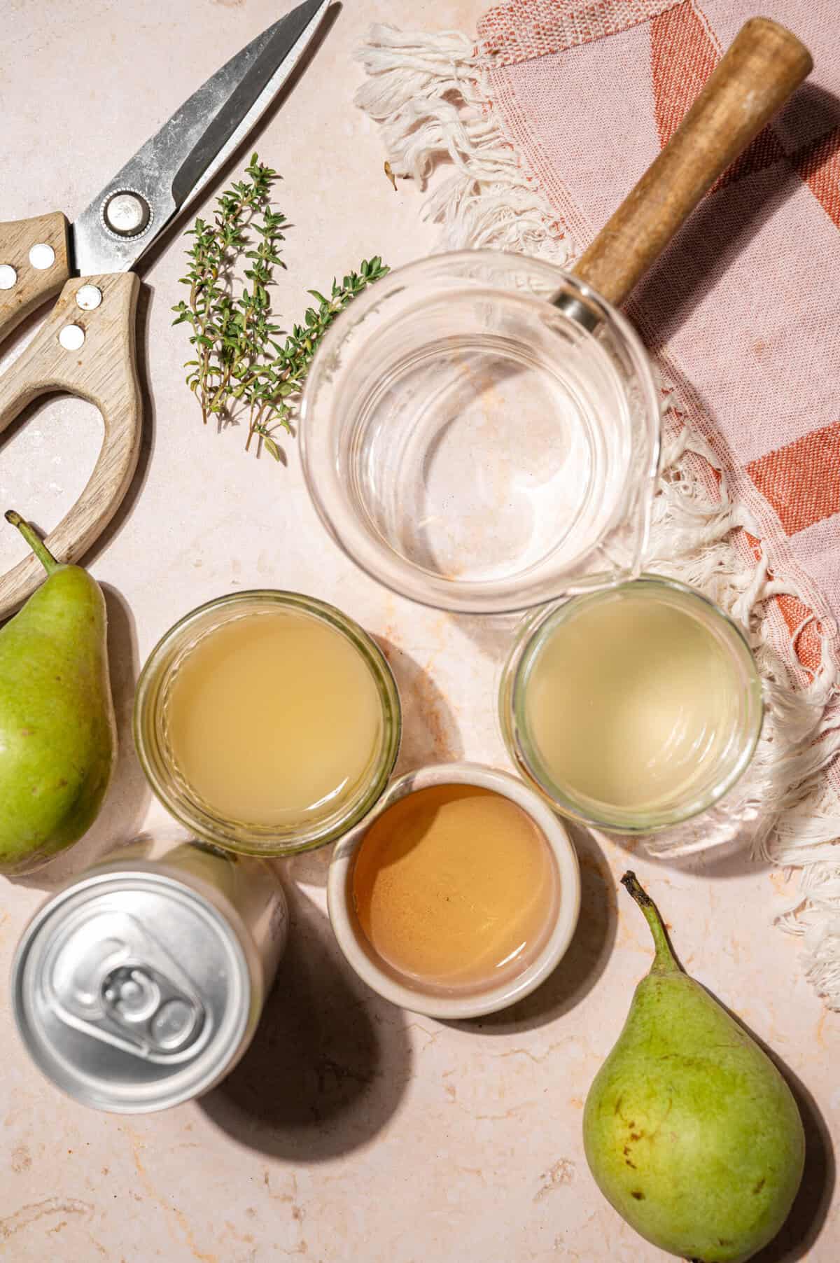 Ingredients for an easy pear cocktail: vodka, pear juice, lemon juice, honey syrup, soda water, fresh thyme, and pears