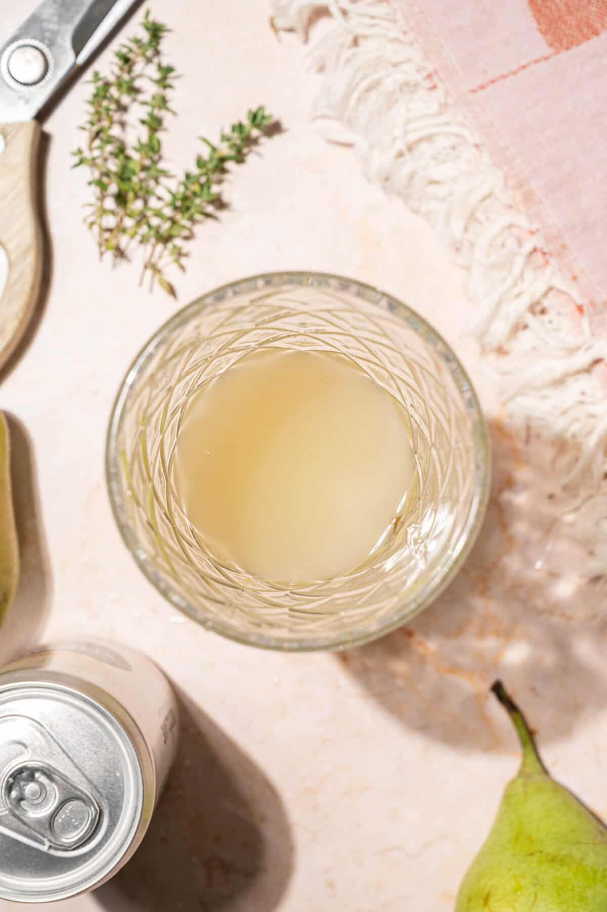 Vodka, pear juice, lemon juice, and honey syrup combined in a cocktail shaker