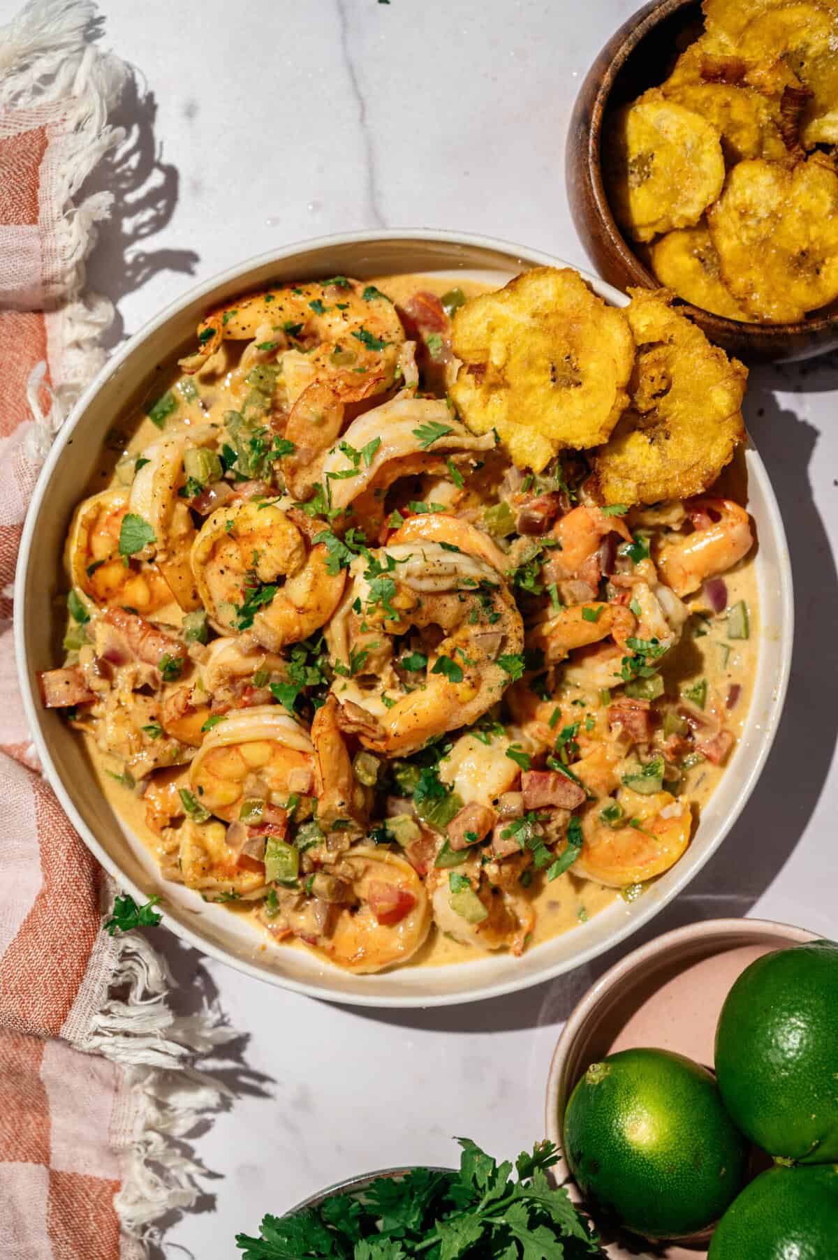 Encocado de camarón with patacones, fresh limes, and cilantro, an authentic Ecuadorian shrimp recipe