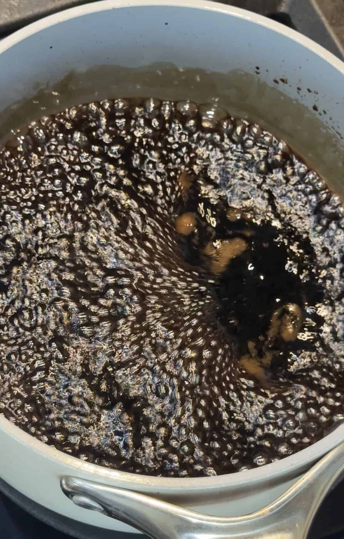 Balsamic vinegar and brown sugar at a rolling boil in a small saucepan